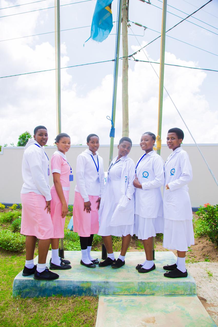 Future health workers by the campus flagpole.
